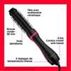 A close-up marketing image of a black and pink Revlon hair dryer and volumizer, with text annotations highlighting its features. Voir les images du produit