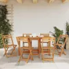 An outdoor patio setting with a wooden table and chairs. Voir les images du produit