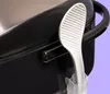 A rice paddle resting in its holder on the side of a rice cooker. Produktbild-Vorschau
