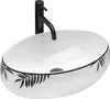 A white oval basin with a black leaf pattern around the rim, and a black faucet. The basin has a drain hole in the center. Náhled obrázku produktu