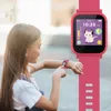 A young girl is looking at her pink smartwatch. Produktbild-Vorschau