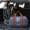 A baby stroller and a diaper bag are packed in the trunk of a car. Náhľad obrázku produktu