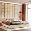 A plush beige bed with a large, upholstered headboard. Anteprima dell’immagine prodotto