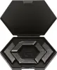 A black hexagonal case with a lid open, revealing a set of metallic hexagonal pieces arranged inside. The pieces have markings on them, and a larger 'G' logo is visible in the center of the case. Produktbild-Vorschau
