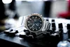 A silver Casio Edifice watch is placed on a black DJ mixer. Produktbild-Vorschau