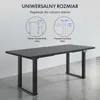 A diagram illustrating the universal size and adjustability of a desk frame, with a partial view of a black desk. Podgląd zdjęcia produktu
