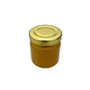A small, round glass jar filled with a golden-yellow substance, likely honey, with a metallic gold lid. Produktbild-Vorschau