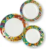 Three plates with colorful, mosaic-like patterns around the rim, arranged in a cluster. Anteprima dell’immagine prodotto