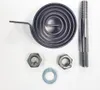A collection of metal parts, including a spiral spring, a threaded bolt, two nuts, and a washer, laid out on a white background. Produktbild-Vorschau