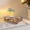 A decorative wooden sled with a lantern on top, set on a white surface. Voir les images du produit