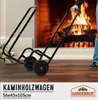A person is using a black log cart in front of a fireplace. Anteprima dell’immagine prodotto