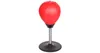 A red mini boxing ball on a black base with a silver spring stand, isolated on a white background. Anteprima dell’immagine prodotto