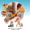 Close-up of hands demonstrating how to open a wooden cable management box, with a baby and a cat in the foreground. Produktbild-Vorschau