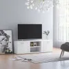 A white TV stand with a television on top, placed in a living room setting with a rug and artwork. Produktbild-Vorschau