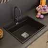 A modern kitchen sink with a black faucet and a bowl of figs on the countertop. Podgląd zdjęcia produktu