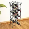 A black metal wine rack filled with wine bottles, placed on a wooden floor next to a large green plant. Podgląd zdjęcia produktu