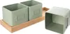 A set of three square metal storage bins with a light green finish, one of which is separate from the other two which are placed on a wooden tray. Náhled obrázku produktu
