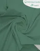 A close-up, swirled view of green fabric, likely a pillowcase, with a small graphic overlay. Produktbild-Vorschau