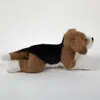 A plush toy beagle dog lying down on a white background. Produktbild-Vorschau