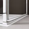Close-up view of the bottom corner of a shower enclosure, showing the track and a support post. Voir les images du produit
