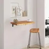 A wooden wall shelf with a jar of cookies and a cup of coffee, next to a wooden stool in a kitchen setting. Voir les images du produit
