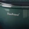 A close-up view of a green pot with a silver logo. Podgląd zdjęcia produktu
