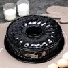 A bundt cake pan with two glasses of white powder, eggs, and oven mitts in the background. Anteprima dell’immagine prodotto