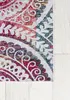 A close-up view of a colorful, patterned rug on a light wooden floor. Podgląd zdjęcia produktu