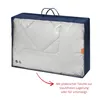 A duvet in a navy blue storage bag with a clear plastic front. Produktbild-Vorschau