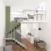 Interior view of a modern loft apartment with a staircase, kitchen area, and dining nook. Produktbild-Vorschau