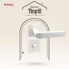 A white door handle set is displayed against a light beige background with a decorative arch. Produktbild-Vorschau