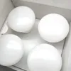 Four white spherical light bulbs are arranged in a white box. Náhled obrázku produktu