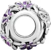A close-up view of a silver charm with purple floral accents. Produktbild-Vorschau