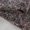 A close-up view of a shaggy rug with a textured, multi-colored design. Podgląd zdjęcia produktu