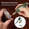 A hand is holding a mini electric rotary tool and engraving a stone. Náhled obrázku produktu