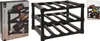 A black plastic wine rack is shown from the front, with a box of the same product to the left. A small inset image on the right shows a similar wine rack with bottles. Produktbild-Vorschau