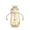 A baby bottle with a straw and a crown-shaped lid, presented on a white background. Produktbild-Vorschau