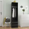 A tall black wardrobe with two items of clothing hanging inside, placed next to a white chest of drawers and a chair with a bag and umbrella on it. Anteprima dell’immagine prodotto