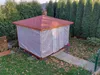 A transparent tarp covering a gazebo in a garden setting with fallen leaves. Anteprima dell’immagine prodotto