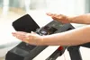 A close-up shot of a person's hands on the console of a treadmill. Produktbild-Vorschau