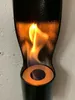 A close-up view of a black ethanol fireplace with a flame burning inside. Produktbild-Vorschau