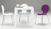 A white table with three chairs around it. One chair is purple, and two are white. A cup and some placemats are on the table. Podgląd zdjęcia produktu
