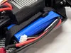 A close-up view of a battery and electronic components within a remote-controlled vehicle. Voir les images du produit