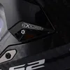 A close-up view of a black helmet with carbon fiber texture and a silver 'EXPLORER' logo. Produktbild-Vorschau