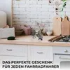 A kitchen counter with a decorative bicycle and cutting boards. Produktbild-Vorschau