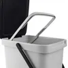 A close-up view of the top of a gray plastic trash can with its lid open. Produktbild-Vorschau