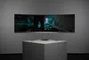 A curved gaming monitor is displayed on a white pedestal against a gray background. Náhľad obrázku produktu
