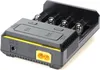A close-up, slightly angled view of a black and gray battery charger with yellow accents. Produktbild-Vorschau