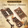 A collection of miniature wooden house kits, resembling book nooks, arranged on a textured background. Voir les images du produit