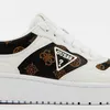 A close-up view of a white and brown Guess sneaker with the Guess logo visible. Produktbild-Vorschau